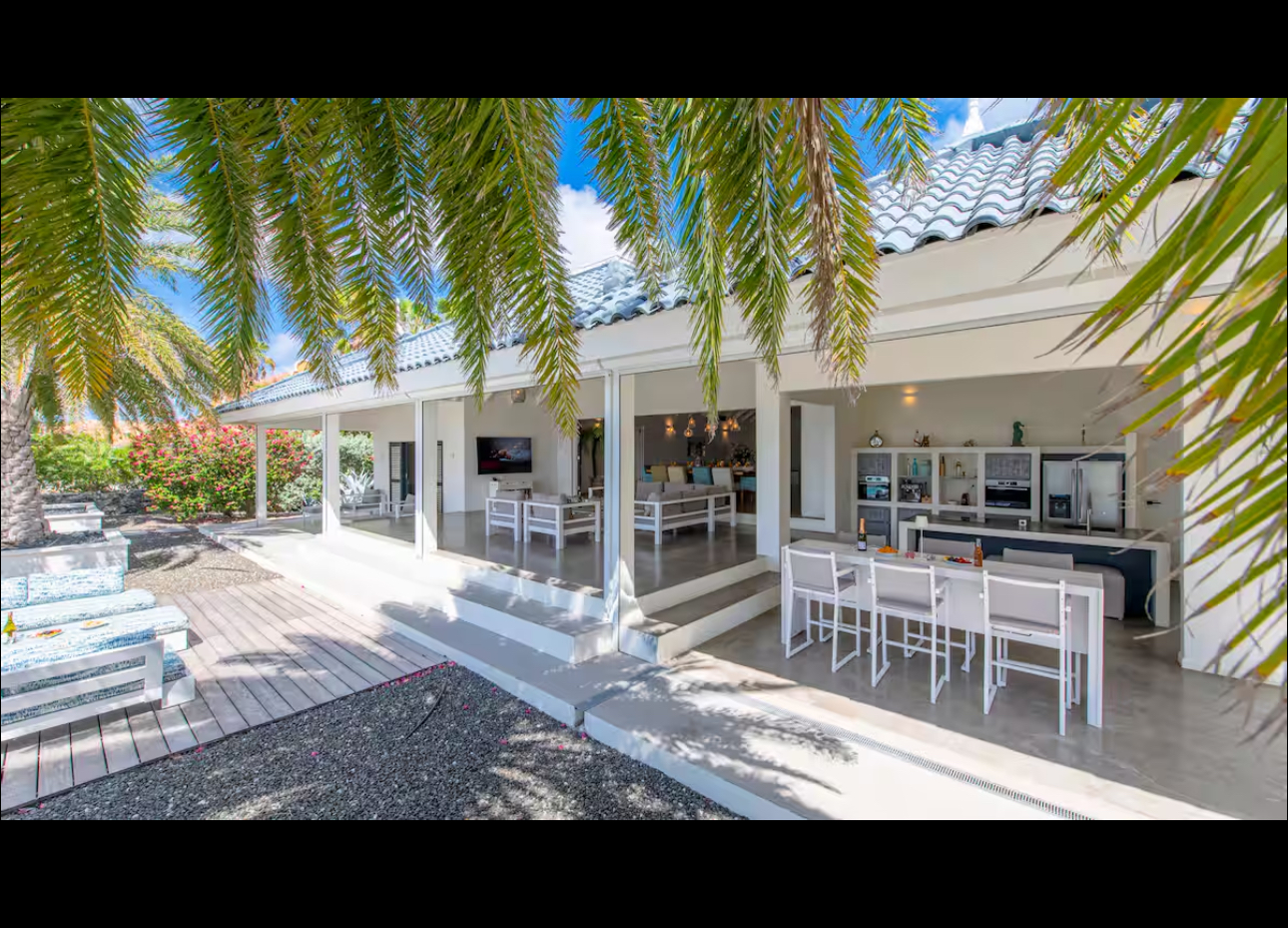Open-air entertaining area with kitchen, bar, and lounge