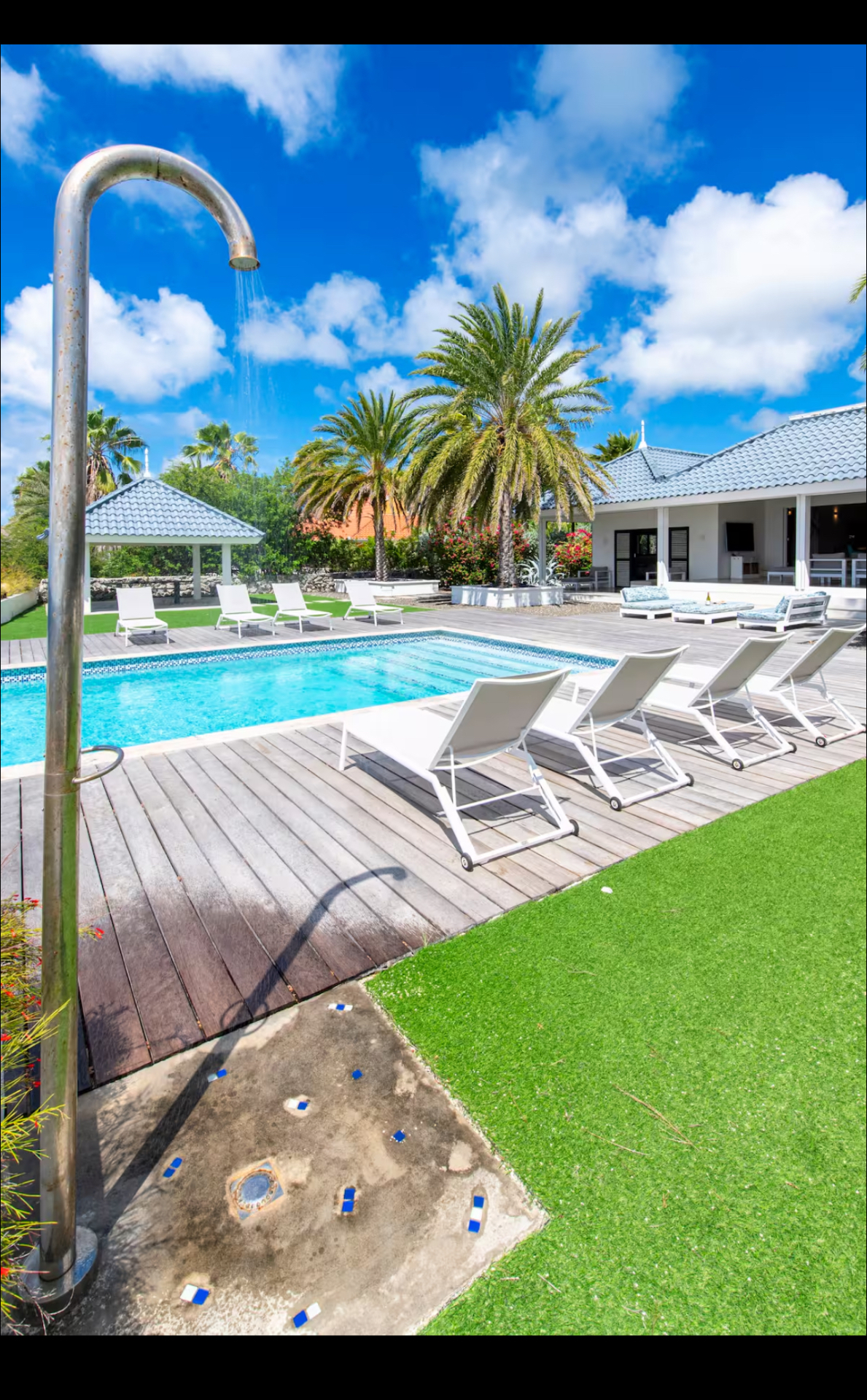 Pool deck with outdoor shower and lounge seating